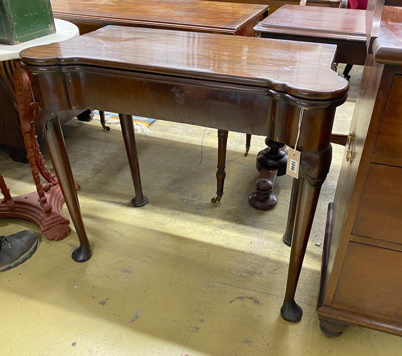 An 18th century mahogany folding tea table, width 83cm, depth 40cm, height 72cm